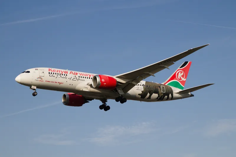 A Kenya Airways Boeing 787 Dreamliner in flight with its landing gear down
